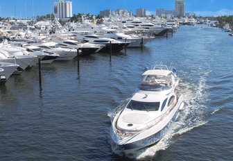 yacht underway passing moored yachts at FLIBS