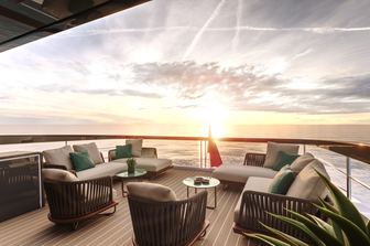 Sunseeker Ocean 156 aft deck at sunset, free standing furniture, red ensign