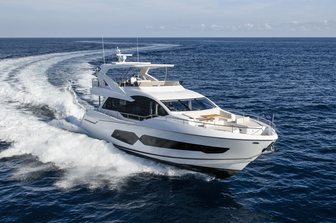 Sunseeker 76 Yacht running shot mid aerial from water towards starboard bow and side profile, calm sea, clear day