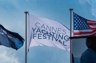 tickets and access to Cannes Yachting Festival flag flying with a USA flag and one other