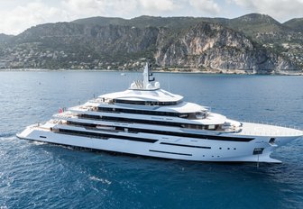 Freire Yachts RENAISSANCE making way, aerial shot over starboard side, mountain landscape in background, reasonably bright day