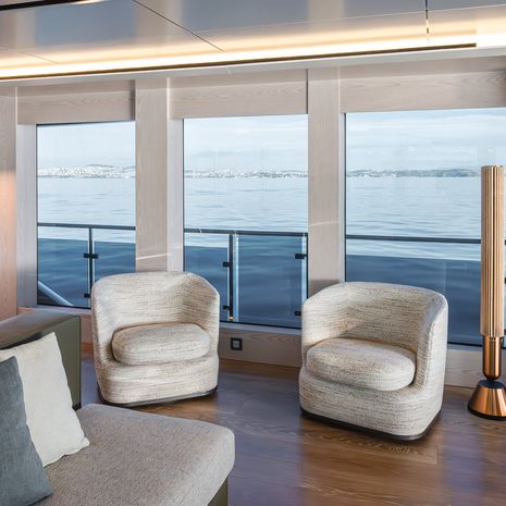 Explorer yacht Mitan main saloon white lounge chairs 