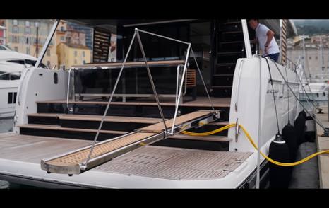 Beneteau Grand Trawler 63 fold-out passerelle extending from the hydraulic swim platform