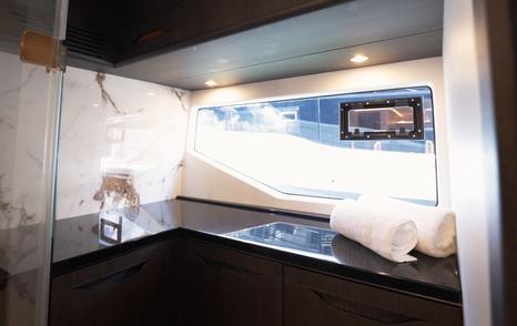 Galeon 520 Fly ensuite bathroom with large window, vanity unit and integrated sink design