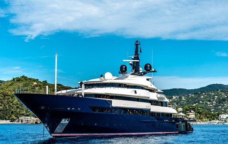 Superyacht with blue hull on anchor