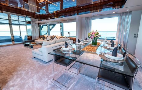 Superyacht Taku main saloon dining area with glass table