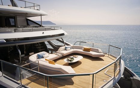 Outside patio area with large u-shaped sofa on Azimut Grande Trideck