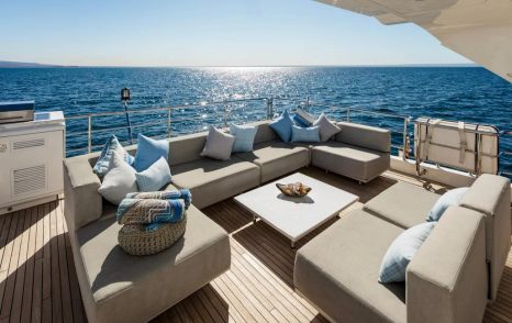 Superyacht Indigo's sundeck with U-shaped sofas