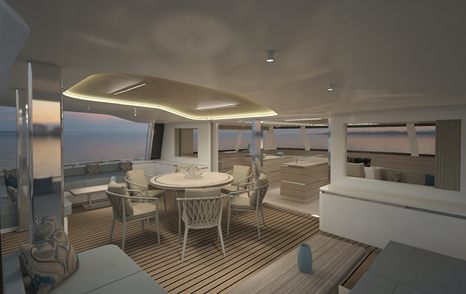 Tables, chairs and sofa on deck of Sunpad on deck of Silent 80 Tri-Deck