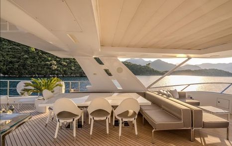 Superyacht Charisma outdoor dining area and sofa