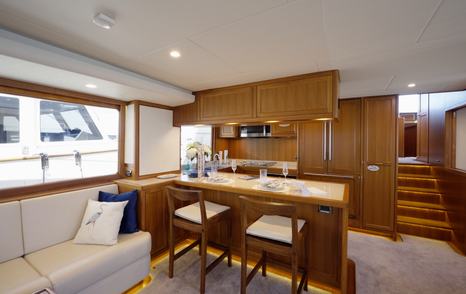Fleming 85 open-plan galley and dinette integrated with the main saloon