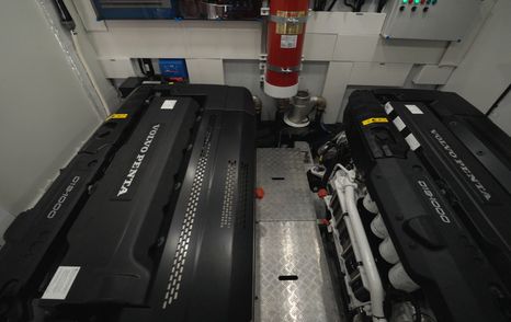 Engine room aboard the Galeon 620 Fly with twin Volvo Penta diesel engines and central service walkway.