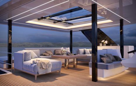 Sunreef Yachts Power ECO 60 night time shot with stylish illumination through exterior salon shown with freestanding furniture