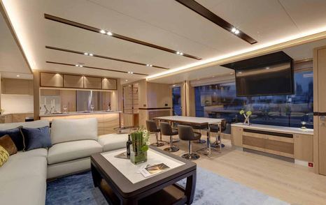 Horizon FD80 interiors, overlooking the main salon with L shaped sofa and coffee table, drop down TV from ceiling and wide windows.