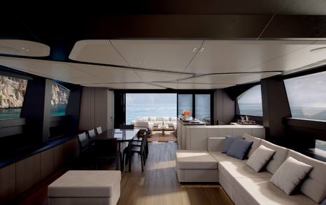 Rendering of Pershing GTX90 motor yacht saloon with aft dining area and L-shaped white seating