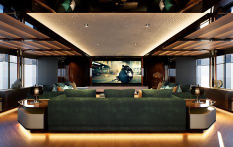 Superyacht Serenity II indoor cinema with green sofa and mounted TV screen