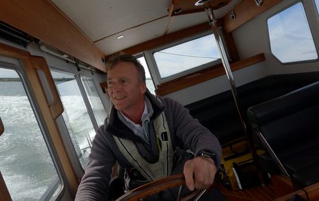 Hugo Andreae smiling at the helm of the Botnia Targa 32, driving the 800hp wheelhouse cruiser during the Prop Gear race.
