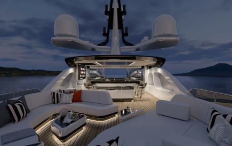 Sundeck onboard Heesen superyacht ATINA, seating and sun pads in foreground with sheltered wet bar in background. 