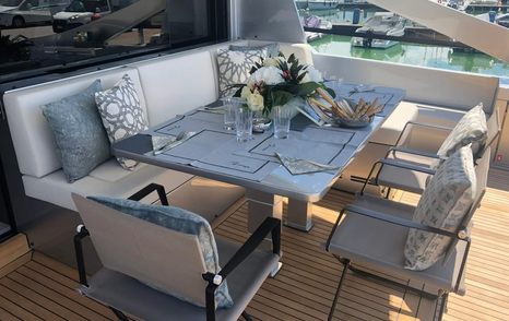 Pershing motor yacht Queen B Sport aft deck dining area 