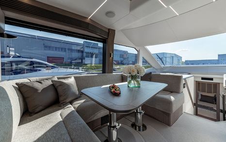 Galeon 560 Fly motor yacht saloon with beige U-shaped sofa 