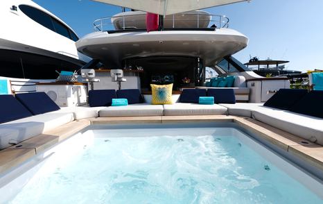 Benetti Oasis 34M Oasis Deck pool surrounded by sun loungers and integrated guest seating.