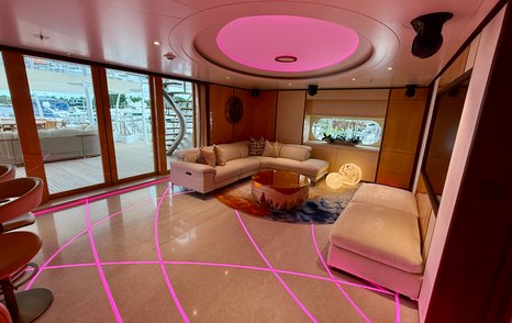 Bridge deck lounge on the Amels 242 Casino Royale with nightclub lighting and lounge seating.