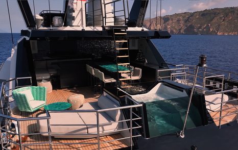 Hidden sunbed seating area on the aft deck of CdM Flexplorer 146 Maverick