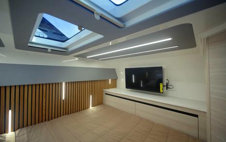 Aquila 45 Sport lower deck cabin with skylight and TV unit, highlighting open layout and natural light