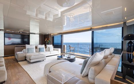 Superyacht Ambar main saloon with starboard balcony and glass sliding doors