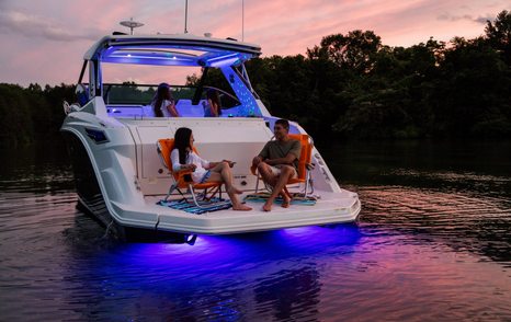 Sea Ray Sundancer 320 aft deck in the evening with lights on