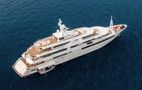 CRN superyacht CHOPI CHOPI shown aerial view over starboard quarter and along side profile in calm sea, tender garage door open with tender being either launched or recovered