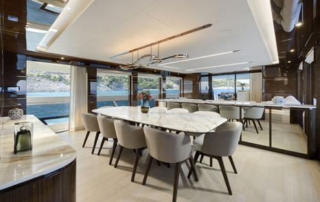 Lazzara UHV 100 Motor Yacht main salon dining area with marbled table