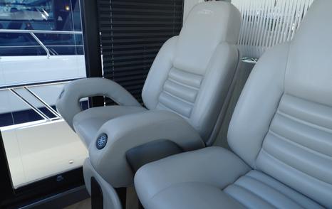 Double helm seating aboard the Galeon 620 Fly beside the side-deck access door.