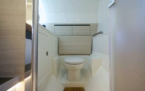Aquila 45 Sport bathroom with toilet and storage, showing compact wet head layout with good headroom