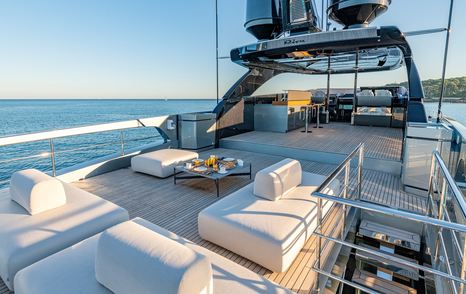 Superyacht Taku upper deck with sunpads and bar area