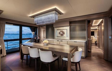 Motor Yacht Saint formal dining area with large windows and contemporary interior finishes