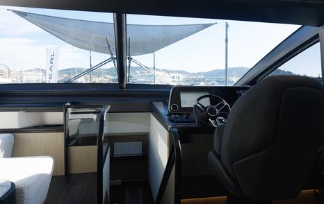 Pearl 73 lower helm with twin seats and forward saloon view