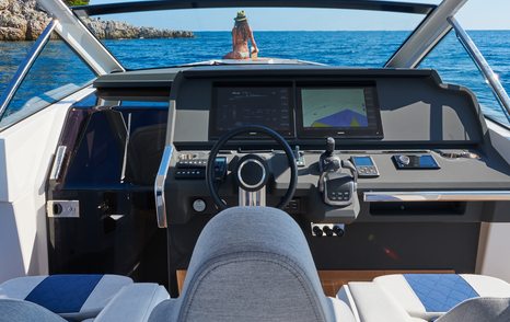 Chase boat helm with steering wheel and technical instruments visible