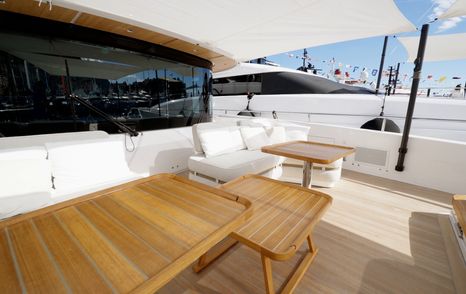 Custom Line Navetta 38 foredeck seating area with tables and flexible layout facing back towards superstructure
