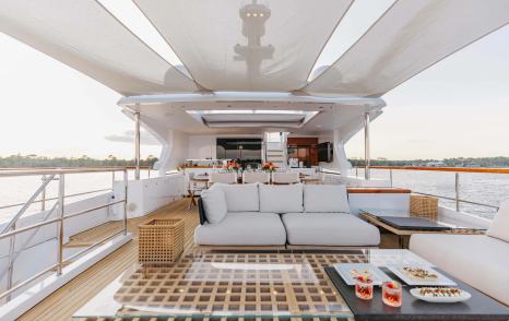 Superyacht Bella Vita upper deck with canopy and white sofas 