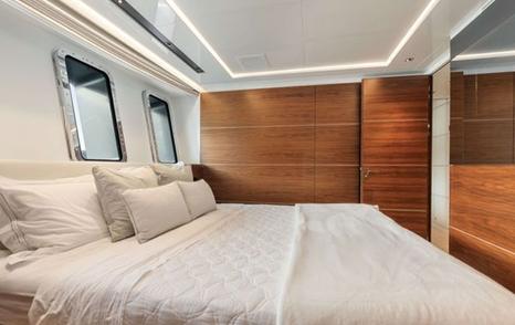 Superyacht Lady A for Sale double guest cabin with portholes and wood wardrobes
