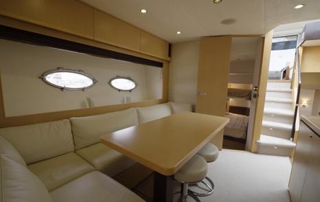 Princess V62 lower dinette and galley with stairs up to helm area