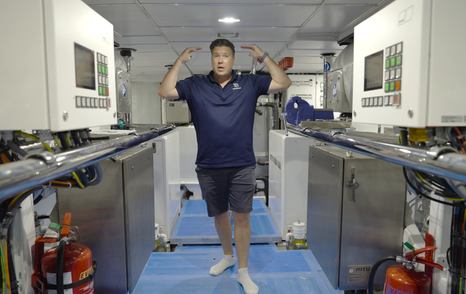 Jack Haines in walkway between the twin MTU engines in the Gulf Craft Majesty 145 engine room