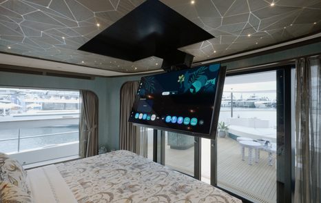 Sirena 118 owner’s cabin with drop-down television above the bed