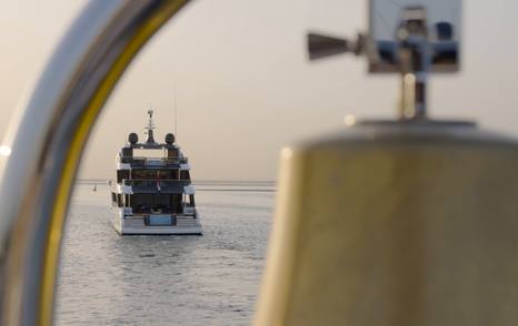 Gulf Craft Majesty 145 viewed from astern at anchor with the beach club and aft decks