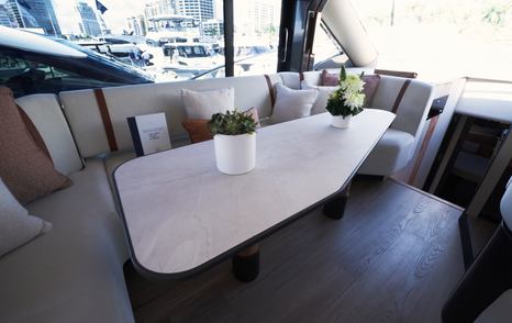 Galeon 520 Fly interior dining area with U-shaped seating and large windows
