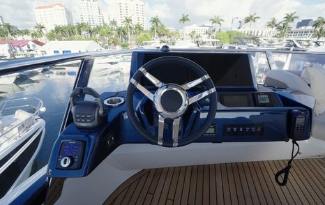Flybridge helm controls and steering wheel aboard the Galeon 620 Fly.
