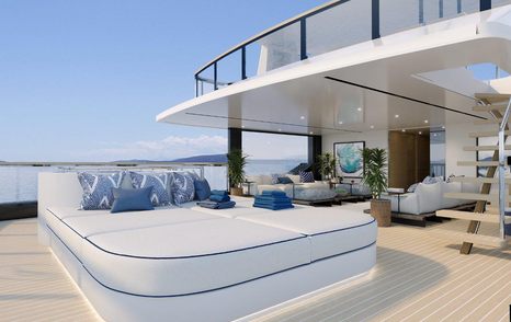 Veranda on sun deck of Benetti B.Yond explorer yacht. Large sunlounger on wooden deck and clear sky in the background