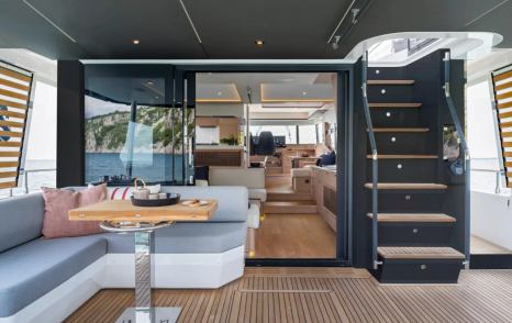 Aft deck with seating area and stairs onboard Beneteau Grand Trawler 63