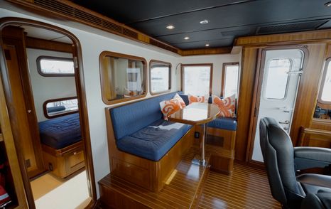 Nordhavn 75 EYF raised pilothouse lounge with watchkeeping settee and companion seating